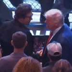 Donald Trump berjabat tangan dengan penonton di acara UFC 316 di tepi oktagon